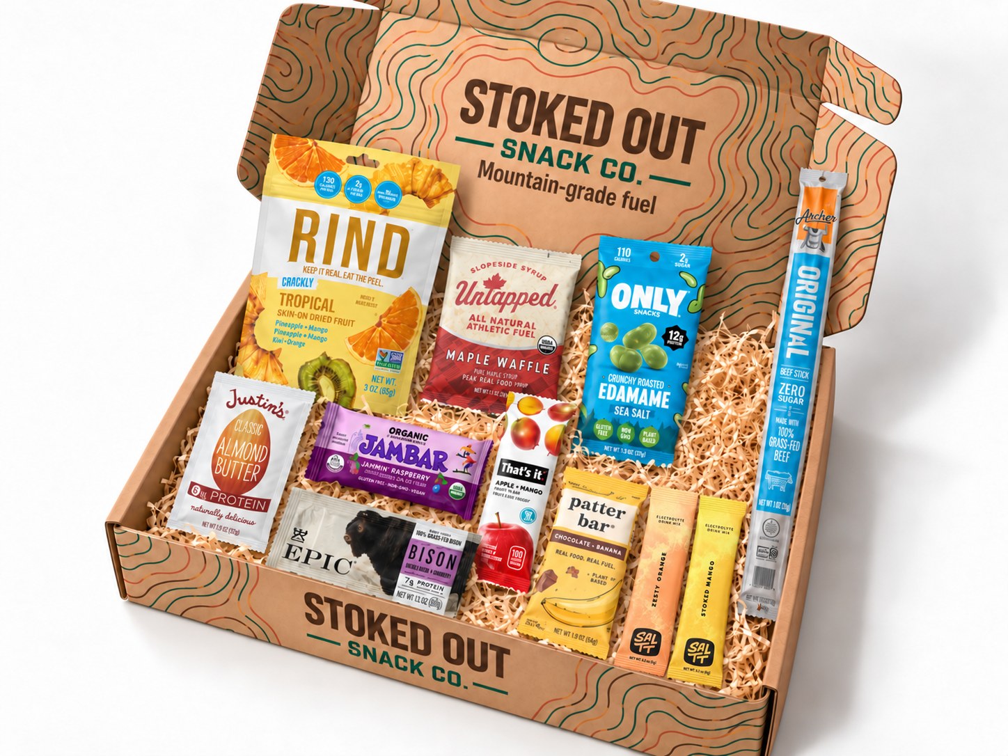 An open Stoked Out standard box packed with eleven individually wrapped snacks, including RIND dried fruit, ONLY edamame, an Archer beef stick, JAMBAR, Untapped waffles, Justin's almond butter, and SALT electrolyte sticks