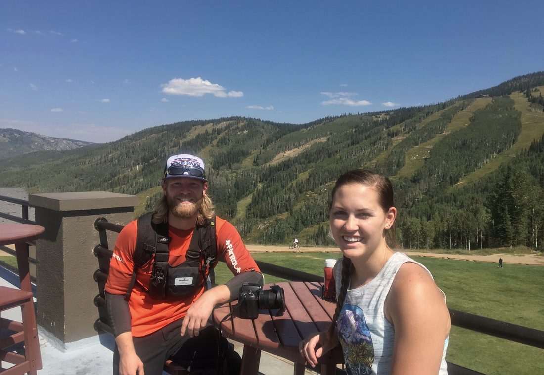 Bass in patrol uniform and Madie on a mountain deck in summer