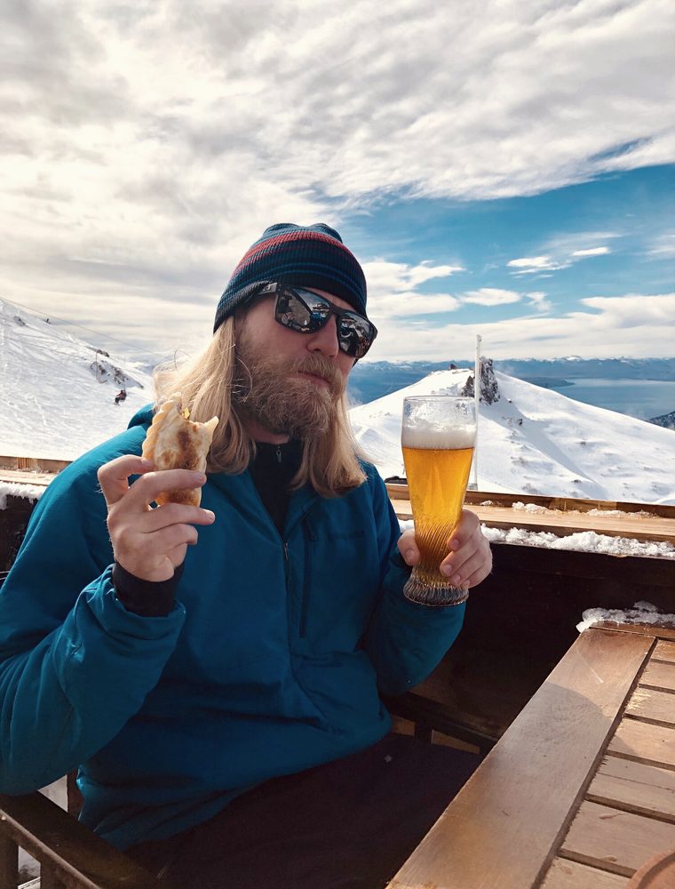 Bass eating an empanada at a high alpine hut in Argentina