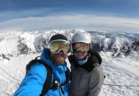 Bass and Madie summit selfie in goggles above the Rockies